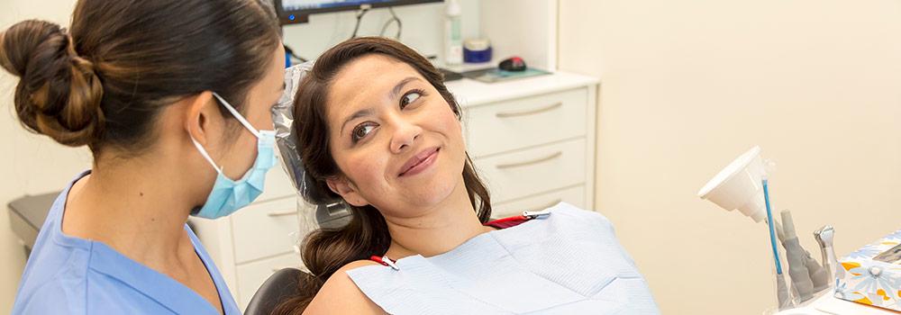 A pregnant mom is shown at the dentist's office using her enhanced benefits through HMSA